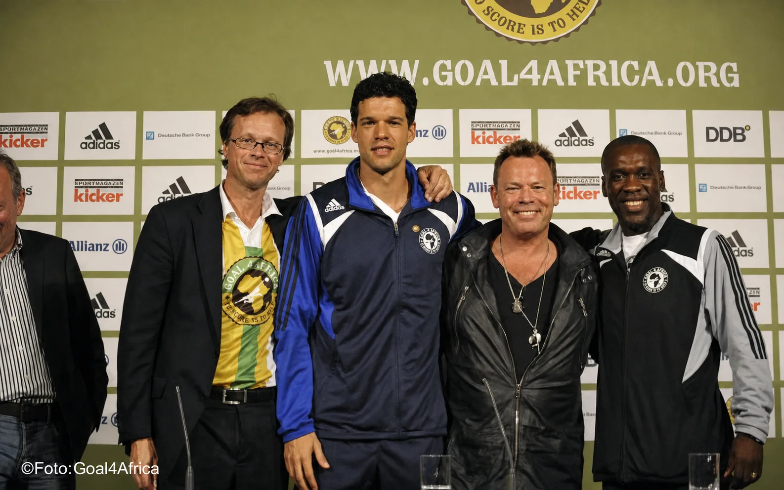 Chris Vermeeren standing with Michael Ballack, Ali Campbell and Clarence Seedorf at the Goal4Africa event in Munich.
